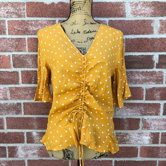 yellow and white polka dot blouse